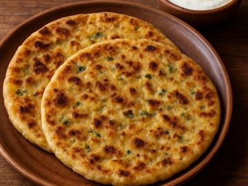 Two flatbreads on a brown plate.