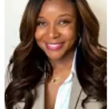 Smiling woman with long wavy hair in professional attire.