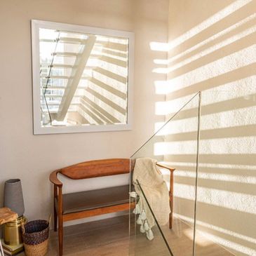 Solid rectangular walls encase each building, giving way to spacious, cantilevered balconies with gl