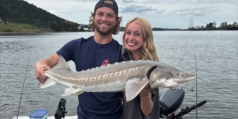 These two loved reeling in this sturgeon