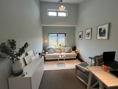 picture of Jana's office including couch, chair, desk and frames 