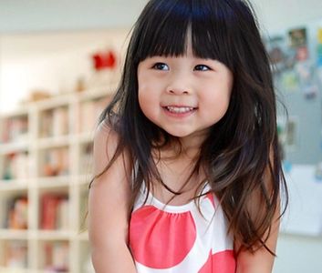 Happy child smiling during playtime at Adventure House childcare in Burnaby