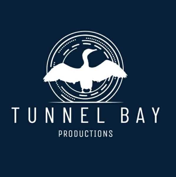 Tunnel Bay Productions logo with a white bird and circular design on dark background.