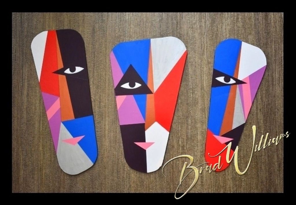 Abstract geometric faces in vibrant colors on a textured background.