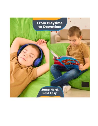 Child relaxing with headphones and reading on a green bean bag.