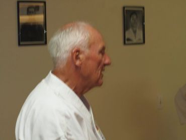 Close-up profile of an elderly, white-haired martial arts master.