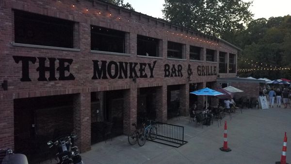 Exterior of The Monkey Bar &amp; Grille at dusk.
