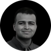 Smiling man with short hair in black and white portrait.