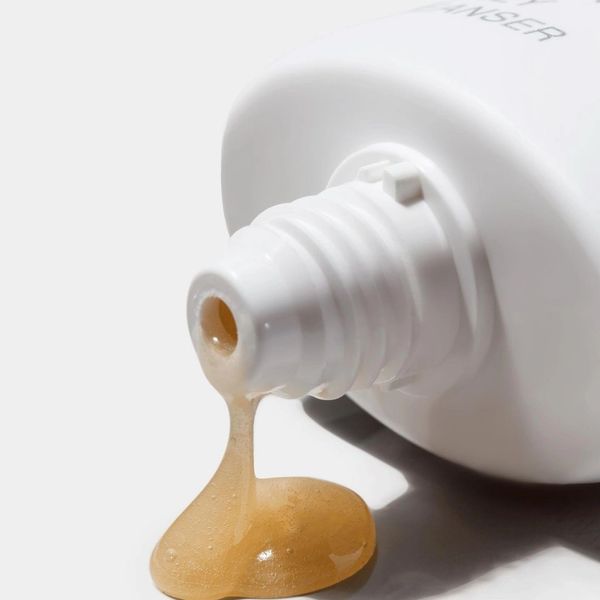 facial lotion dripping out of a bottle