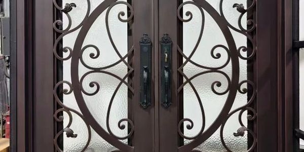 Ornate metal double doors with frosted glass.