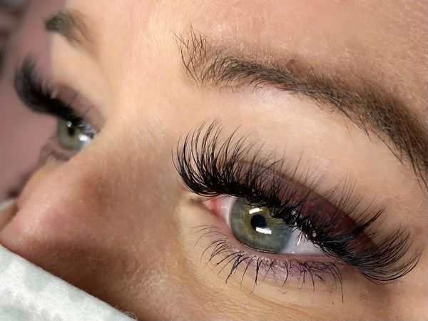 Volume lash extensions on woman with green eyes