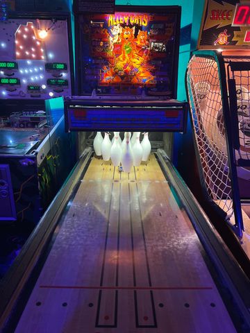 Vintage Alley Cats bowling arcade game with pins set up.
