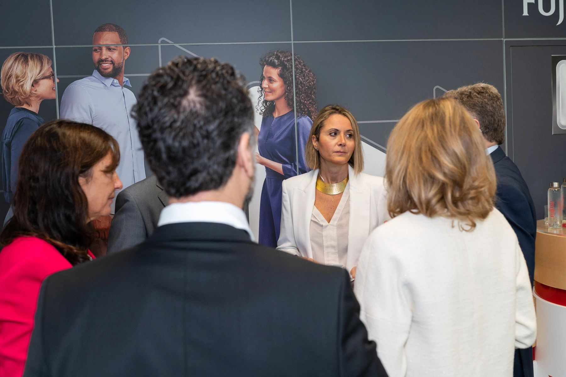 Group of professionals engaged in a conversation during a business event.