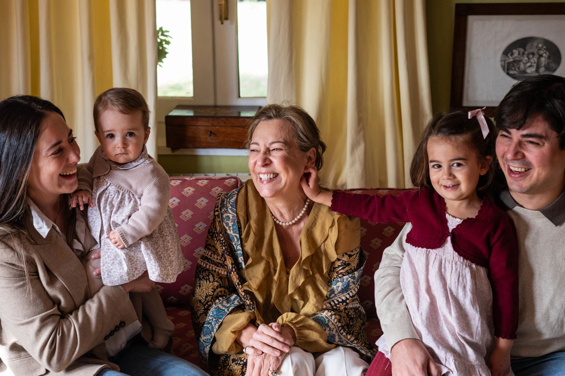 A happy multigenerational family sitting together and smiling.