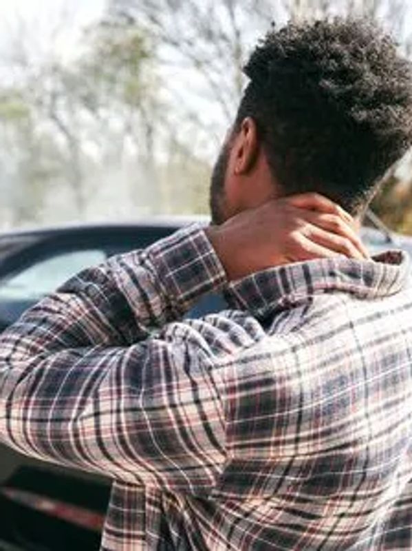 Person holding neck from auto accident injury