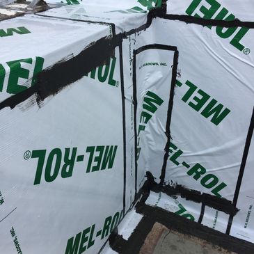 Construction corner with MEL-ROL insulation and black sealing tape.