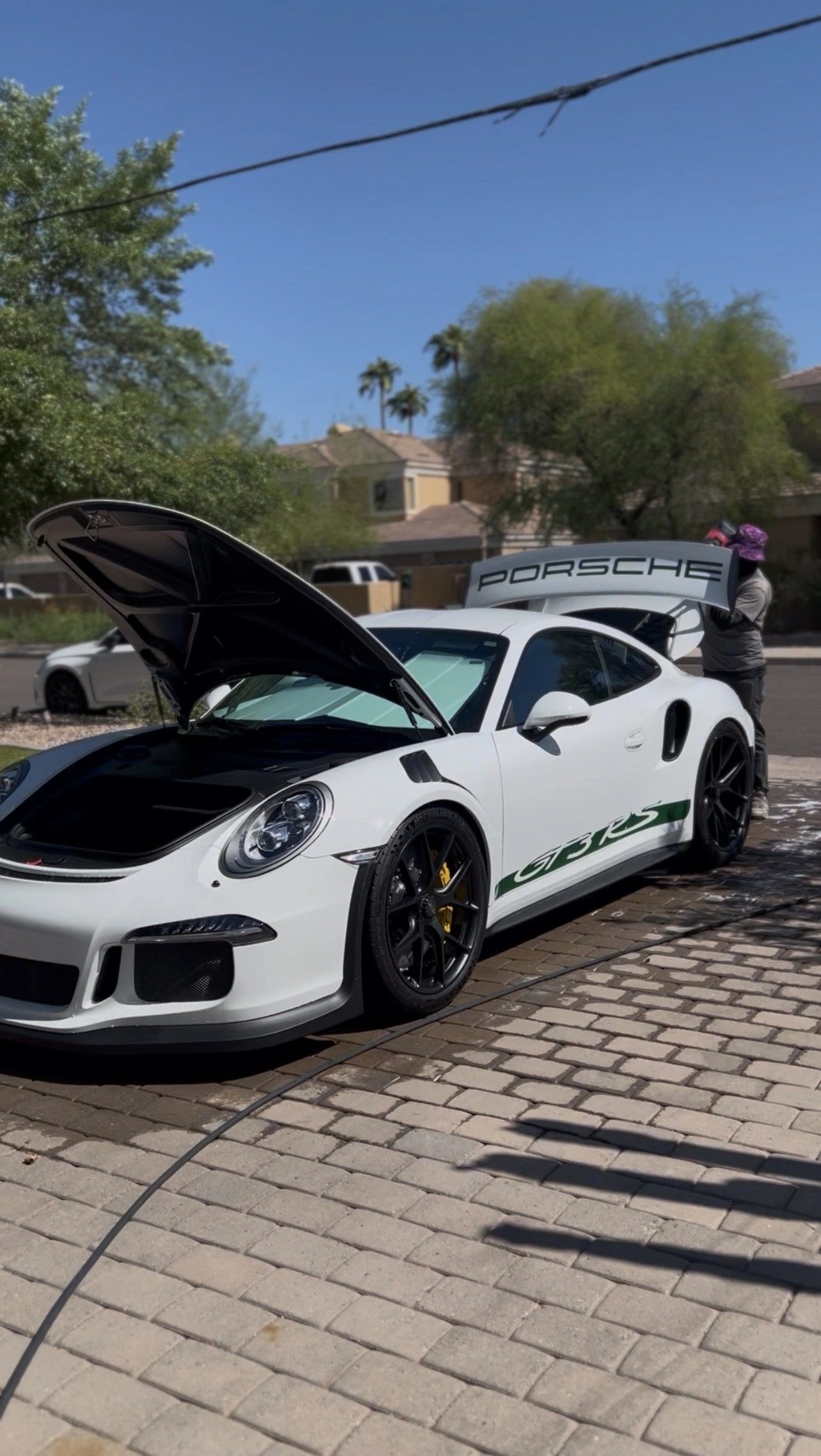 White Porsche 911 GT3 RS on pavers: ceramic coating and paint correction serving Mesa and Scottsdale