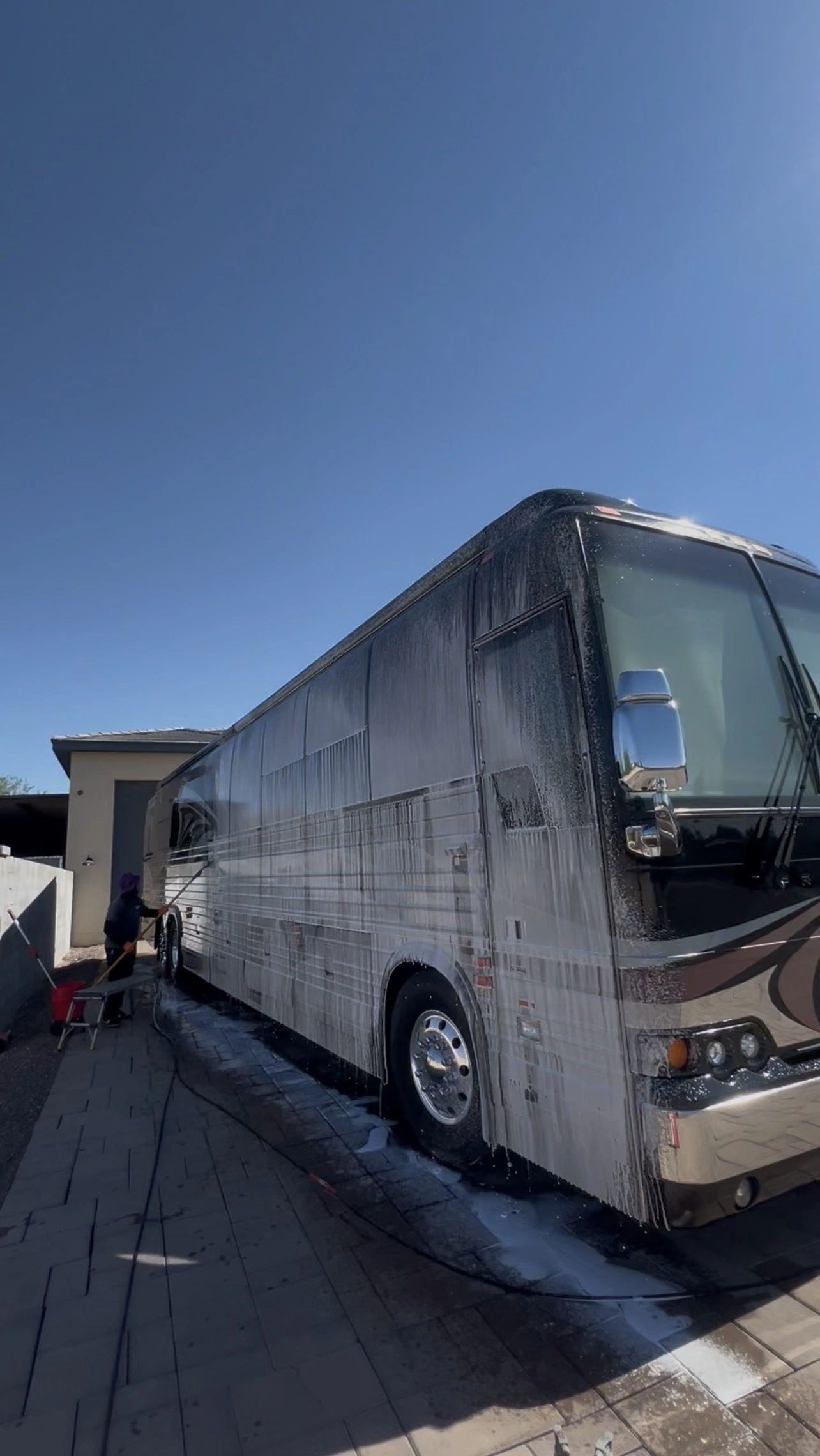 Dialux detailer foam-washing a large motorhome: mobile RV washing serving Mesa and Phoenix Valley
