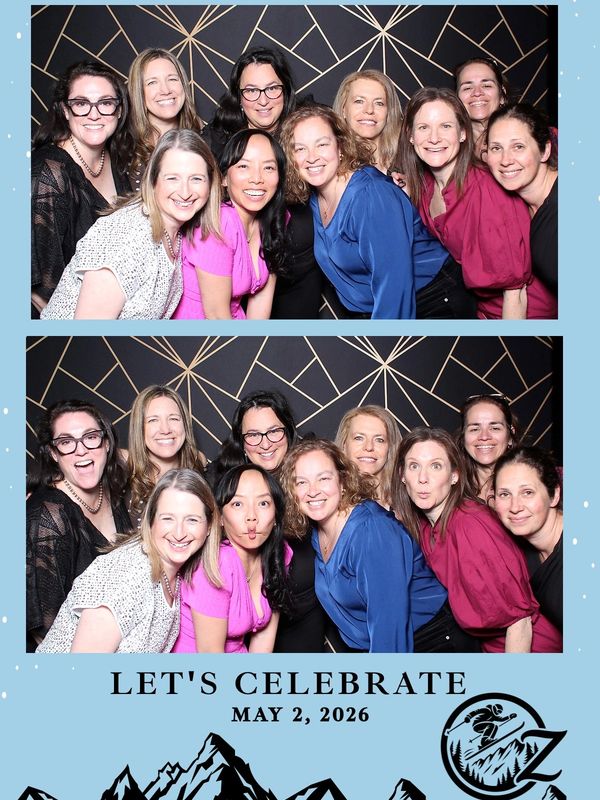 Group of women smiling and celebrating together with a geometric backdrop.