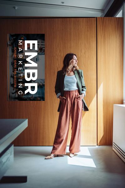 Woman standing in a modern room with wooden panels.