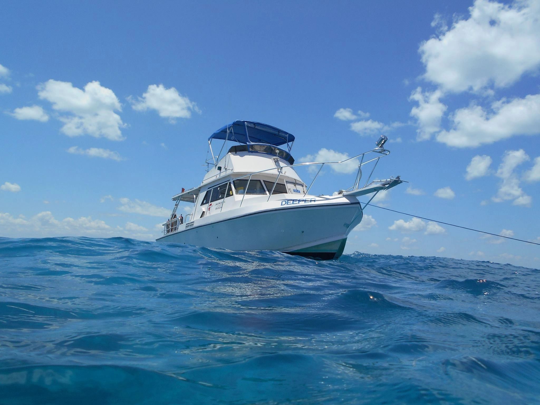 Scuba Dive Boat in waves with blue sky in Key Largo Florida Keys