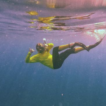 A snorkeler radiates with excitement exploring Key Largo's crystal-clear waters with Sail Fish Scuba