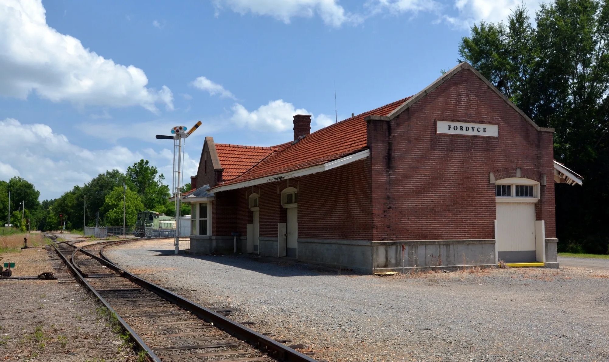Old train station building at Fordyce with railroad tracks.