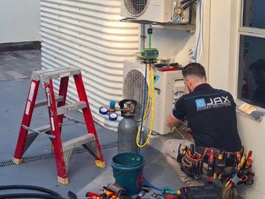 Air conditioning installation and commissioning work being completed on a residential split system a