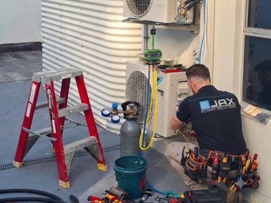Air conditioning installation and commissioning work being completed on a residential split system a