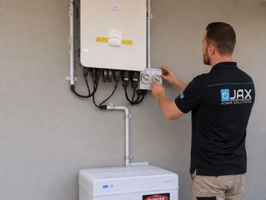 Solar inverter and battery system installation being commissioned by a JAX Power Solutions Electrici
