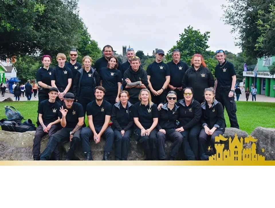 A team photo of KDM Security at Alton Towers in 2019. Everyone is wearing their uniform.
