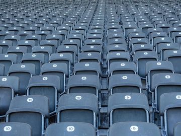 A close up abstract image of an empty stadium seating area.