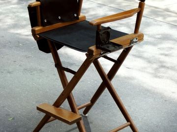 A black and wooden directors chair from a film set.