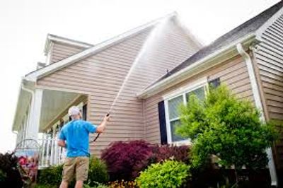 Pressure washing exterior of house