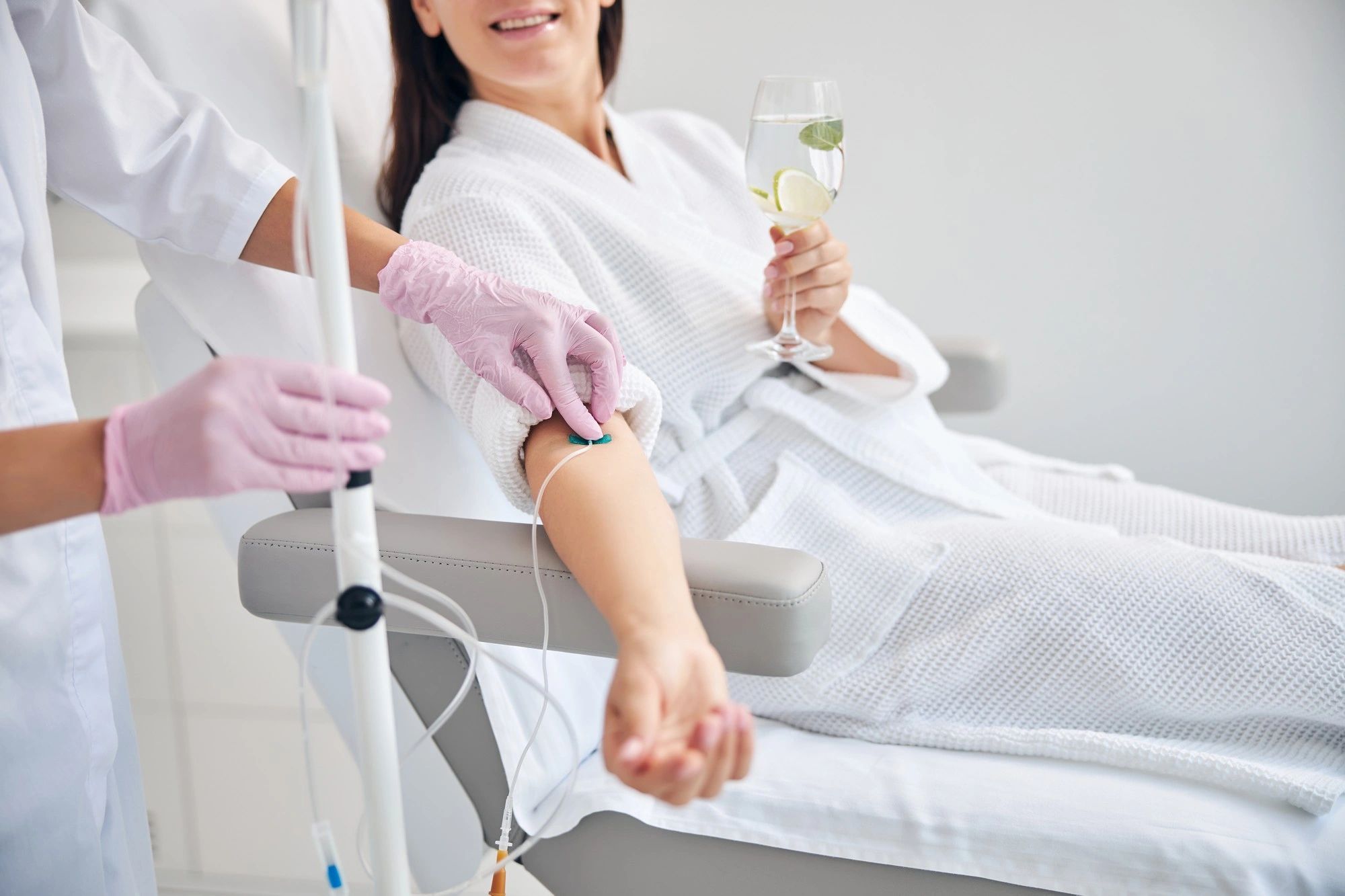 A woman receives IV therapy in a clinic as part of a wellness treatment.