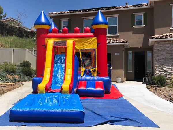 medium-sized water slide jumper rental at a residence in San Diego