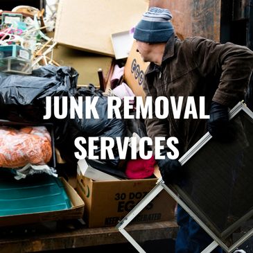 A man in gloves and a beanie rummages through a pile of discarded household items.