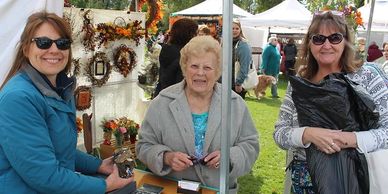 Two patrons and a crafter at the Friends of the Library and Museum's annual Craft Fair at Ketring Park in Littleton. 