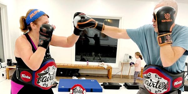 Man and woman doing thai kickboxing punches