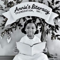 Young girl reading a book under a banner for Annie's Literacy Foundation.