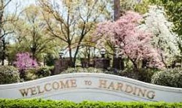 Welcome sign surrounded by blooming trees at Harding.