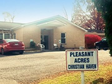 Building with a sign reading Pleasant Acres Christian Haven in front.