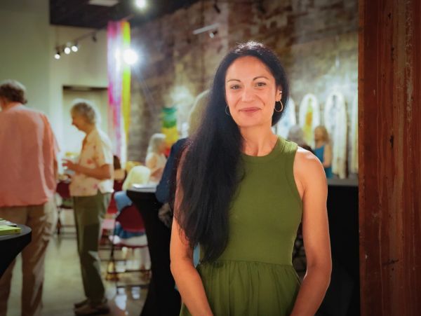 Woman smiling in a casual gathering.