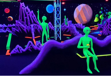 Glowing green aliens in a vibrant cosmic landscape with purple mountains and planets.