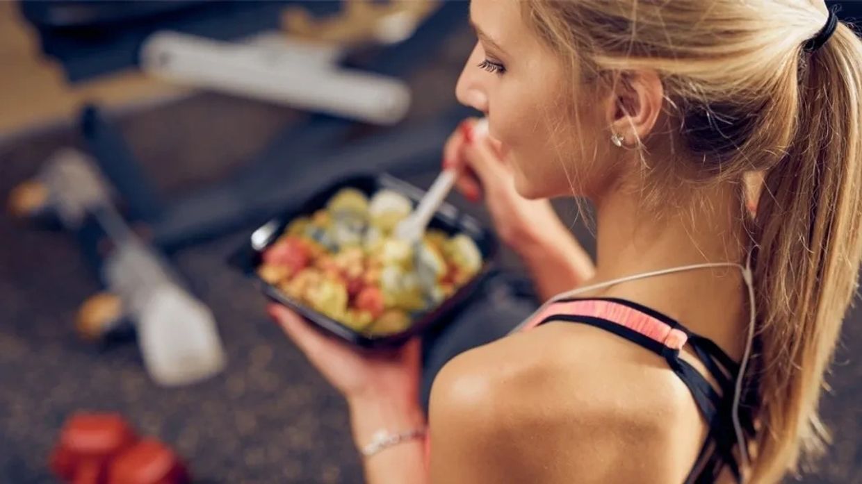 Fit girl eating healthy meal