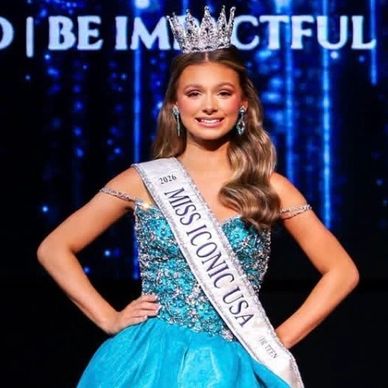 Woman wearing a crown and sash at a beauty pageant.