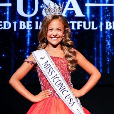 Young girl crowned Miss Iconic USA 2026, smiling confidently.