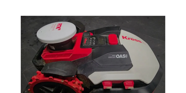 Robotic lawn mower with red and black design, labeled Kress and OAS.