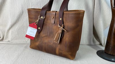 Ladies leather tote with dark brown leather shoulder straps.