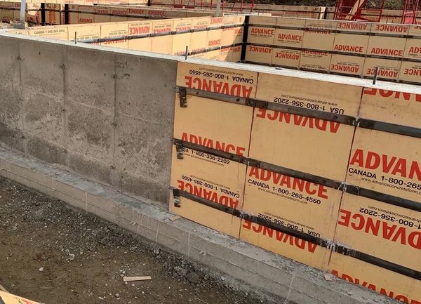 Concrete foundation walls with Advance formwork panels at a construction site.